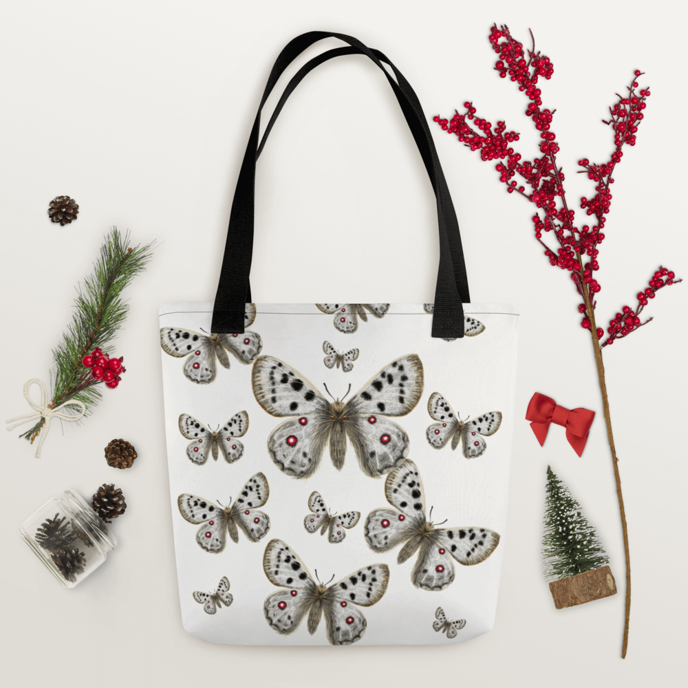 Apollo all-over print tote bag with black handles within Christmas decorations like red berry little branch
