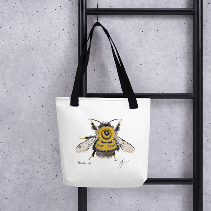 Bumblebee all-over print tote bag with black handles hanging on a ladder
