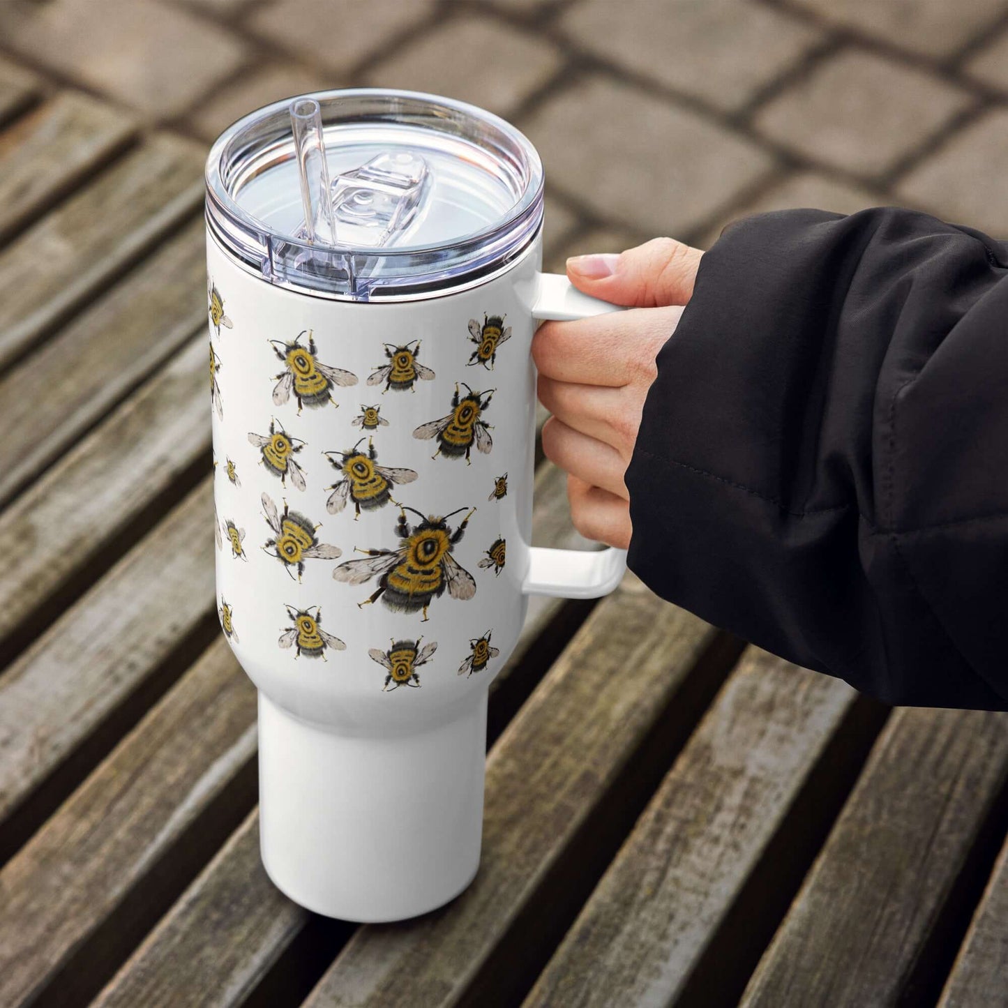 Bumblebee design insulated travel tumbler with handle, perfect for on-the-go drinks and fits in car cup holders.