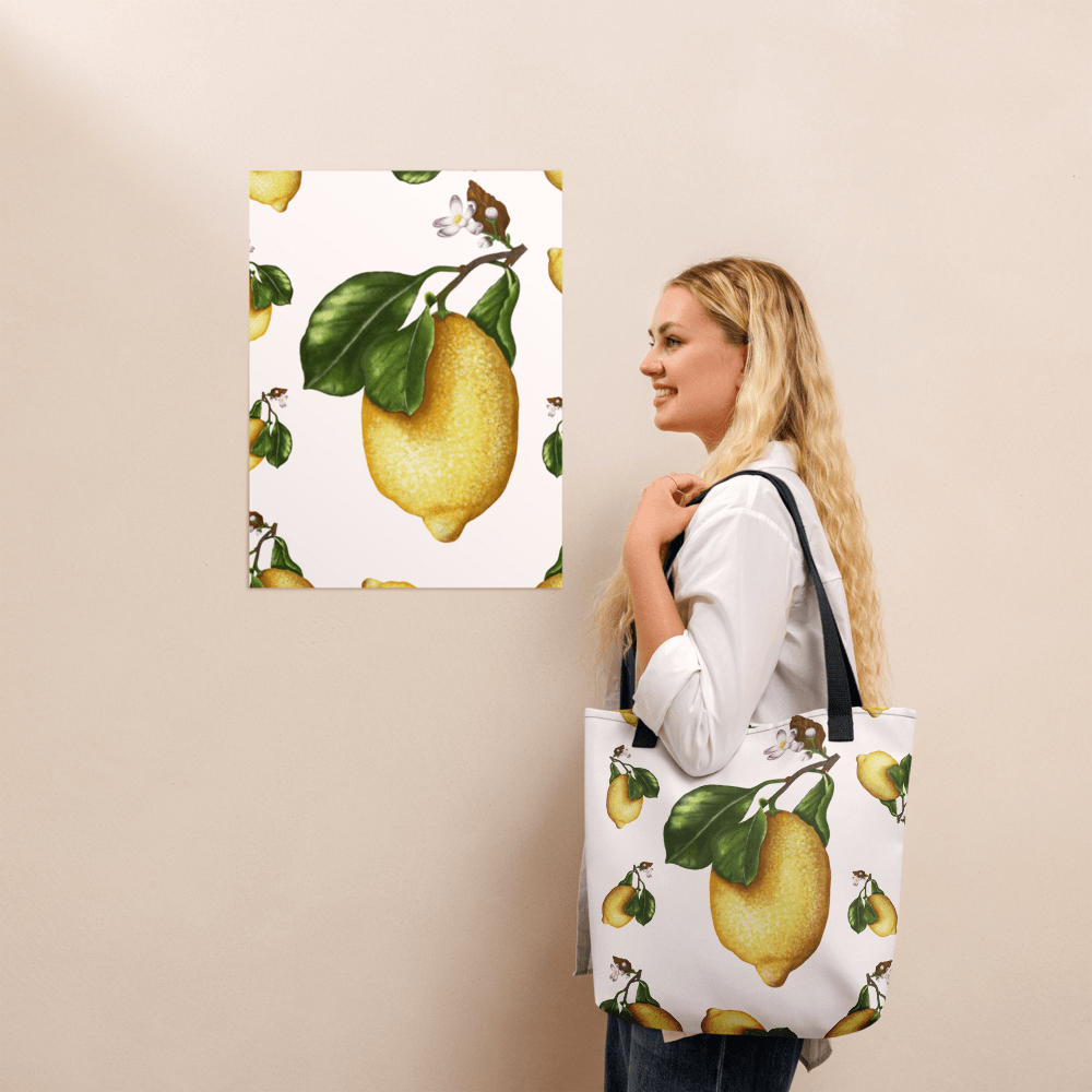 Lemon all-over print tote bag with black handles on a blonde lady's shoulder
