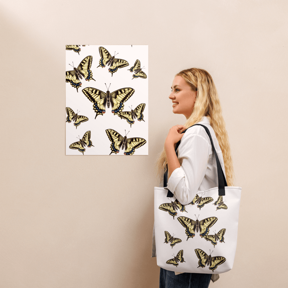 Machaon all-over print tote bag with black handles on a blonde lady's shoulder
