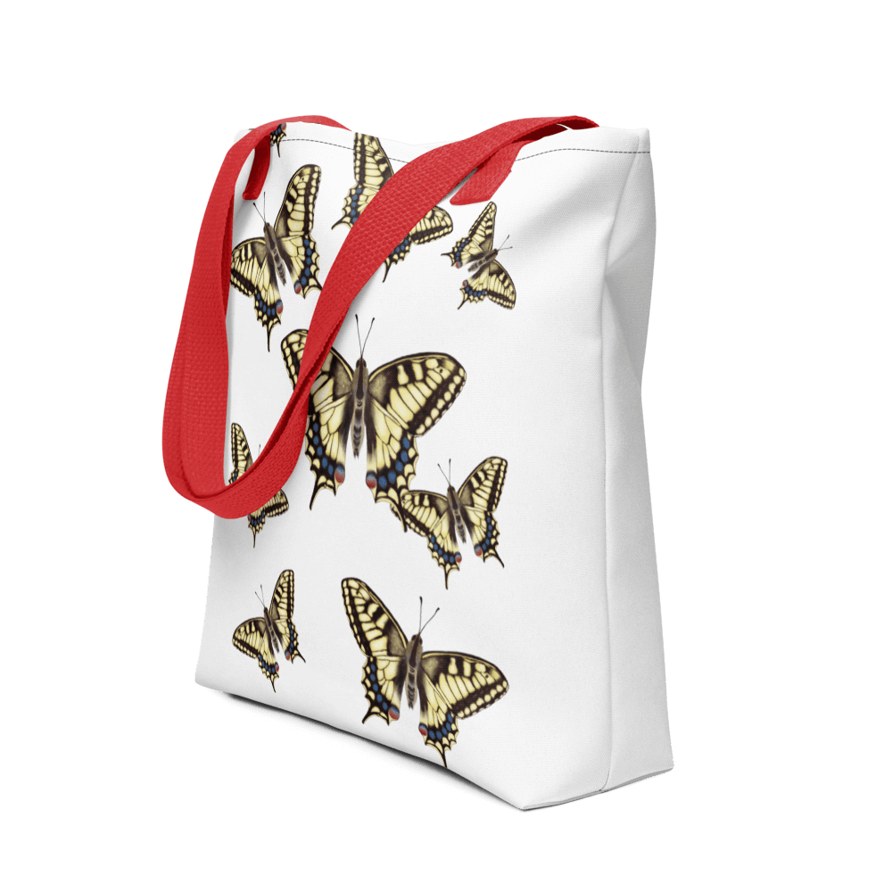 Machaon all-over print tote bag with red handles displayed prominently
