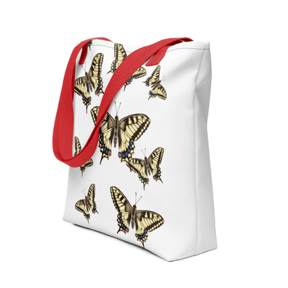 Machaon all-over print tote bag with red handles displayed prominently
