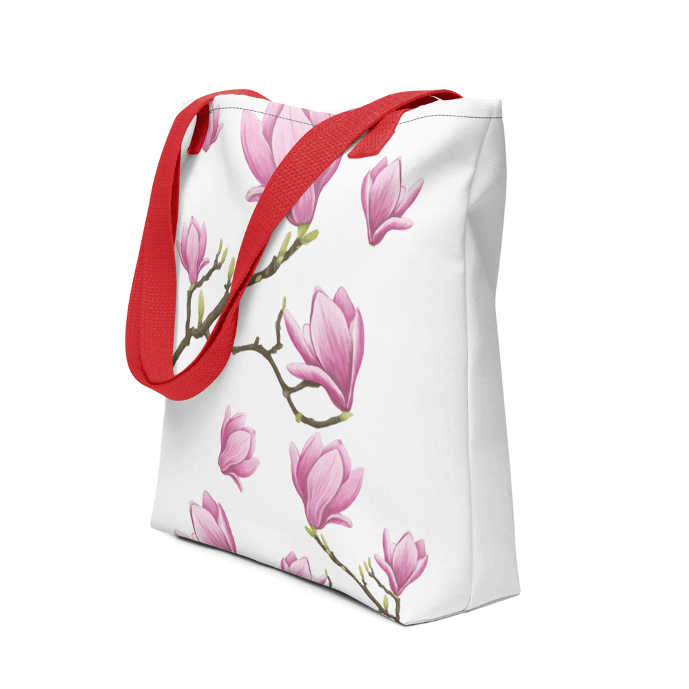 Magnolia all-over print tote bag with red handles displayed prominently
