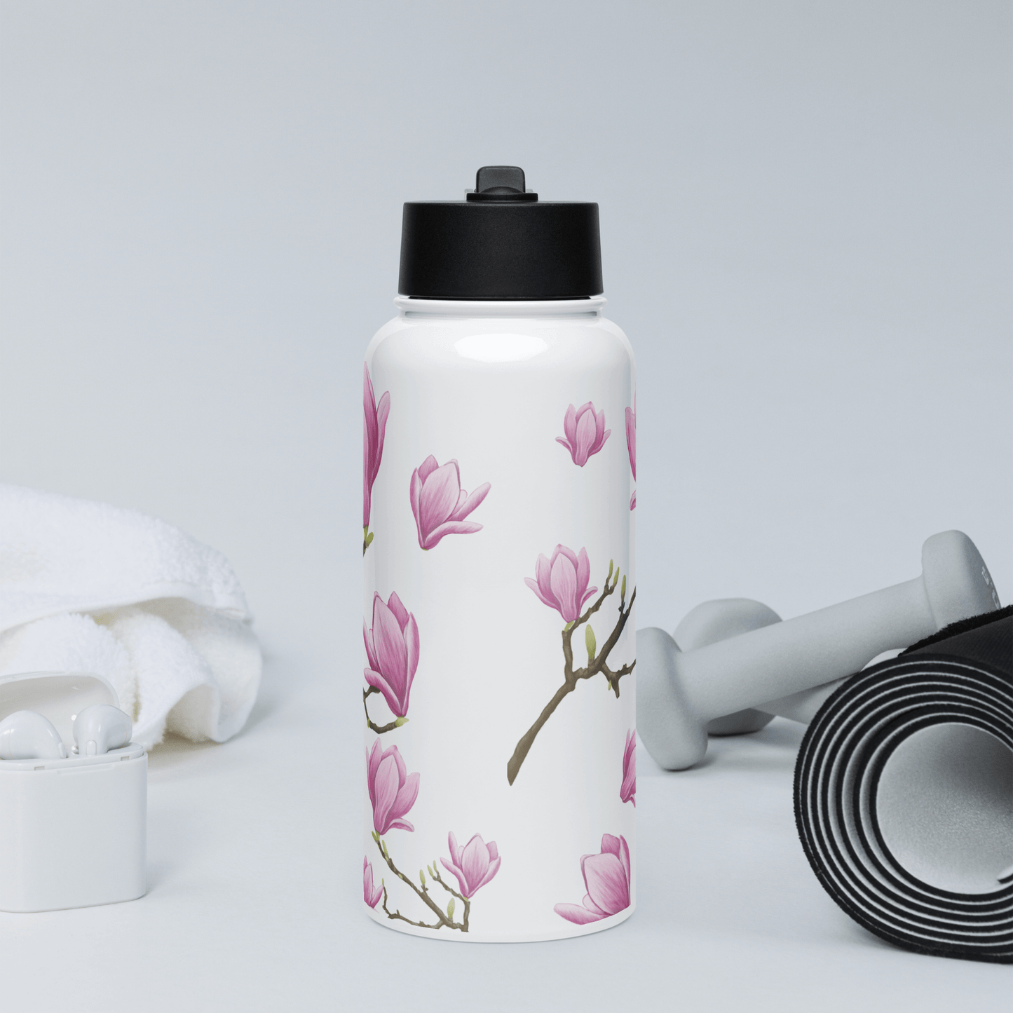 Elegant 32oz Magnolia water bottle on workout surface, perfect for gifts, travel accessories, and active lifestyles.