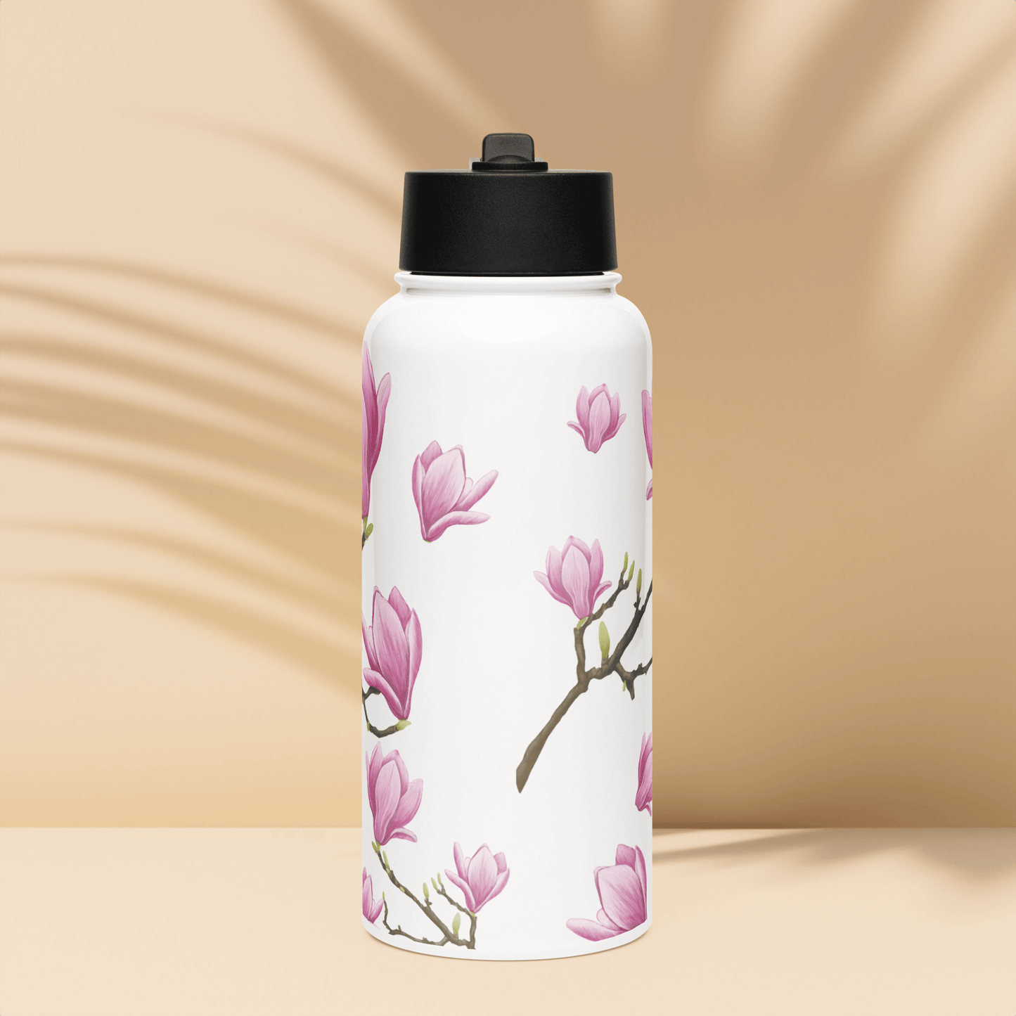 Elegant 32oz Magnolia water bottle with delicate pink floral design, perfect for gifts and travel accessories.