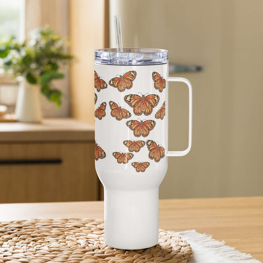 Monarch butterfly insulated tumbler with handle and straw on a wooden table, perfect for travel and hydration.