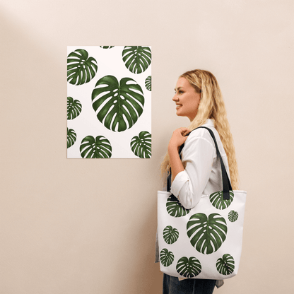 Monstera all-over print tote bag with black handles on a blonde lady's shoulder
