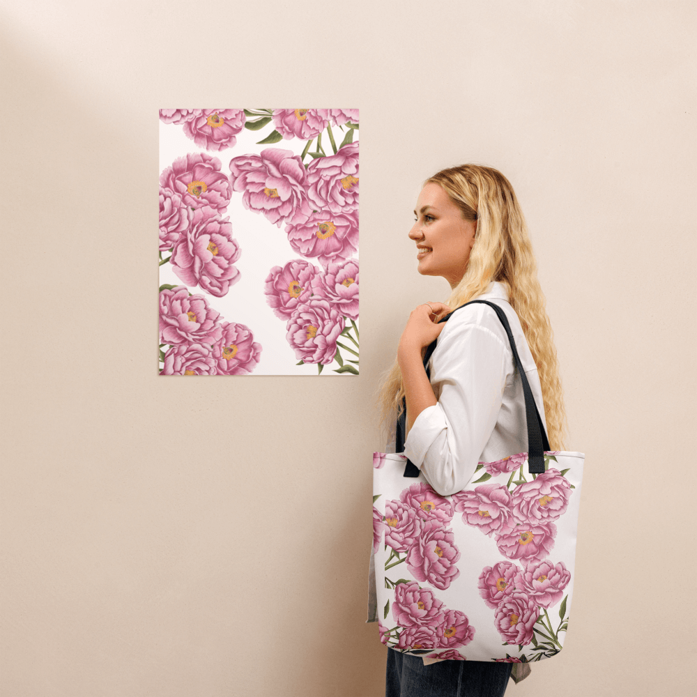 Peony all-over print tote bag with black handles on a blonde lady's shoulder