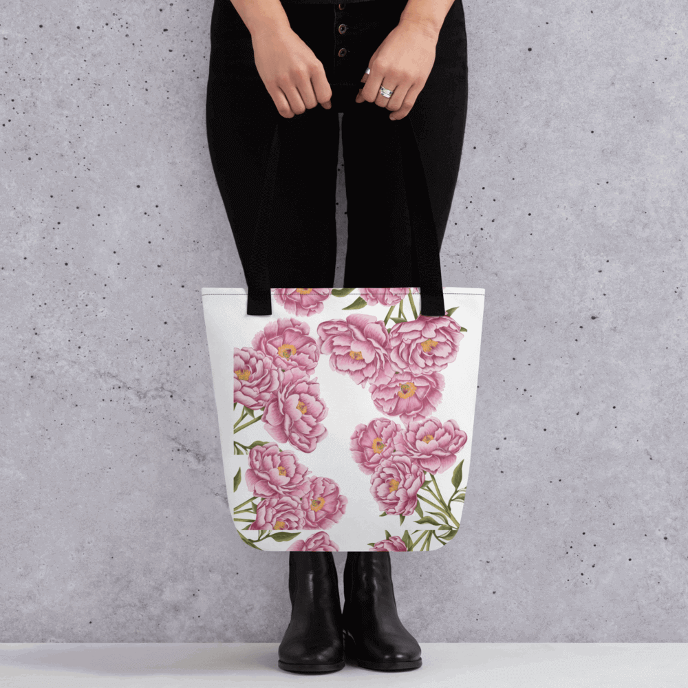 Peony all-over print with black handles held by a person dressed in black with both hands holding it in front