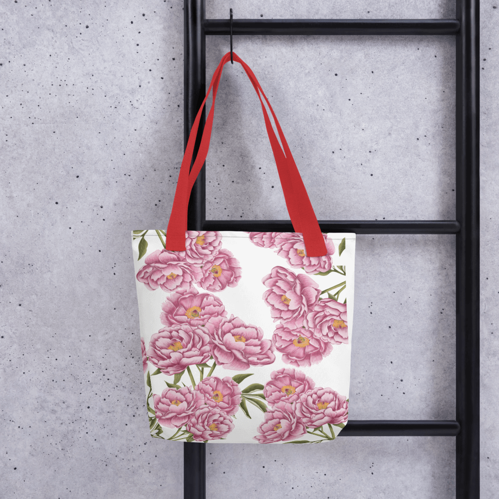 Peony all-over print tote bag with red handles hanging on a ladder
