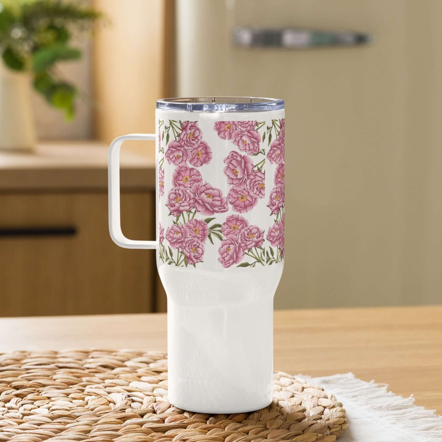 Peony design insulated tumbler with handle on a wooden table, perfect for hot or cold beverages.