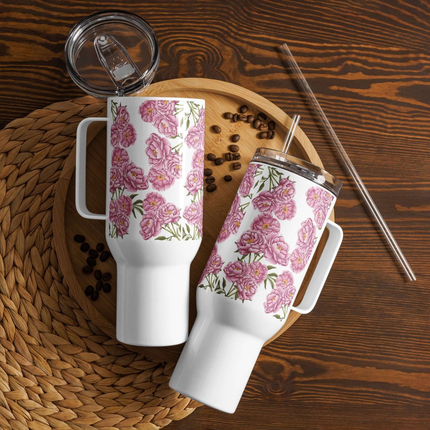 Peony design insulated tumblers on a wooden tray with coffee beans, showcasing travel mugs with handles and straws.