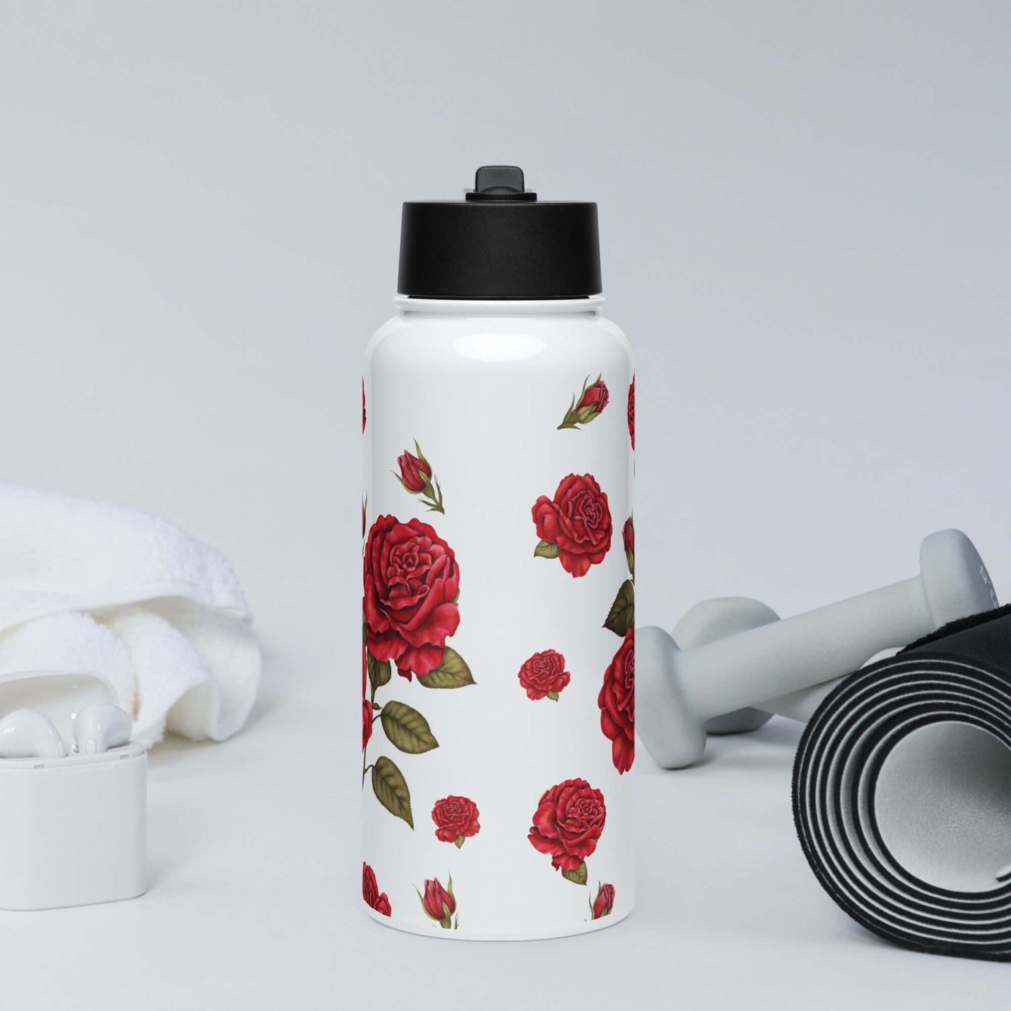 A frontal view of a performance rose water bottle in a gym setting showcases how the romantic red rose design blends artistic flair with a focus on wellness.