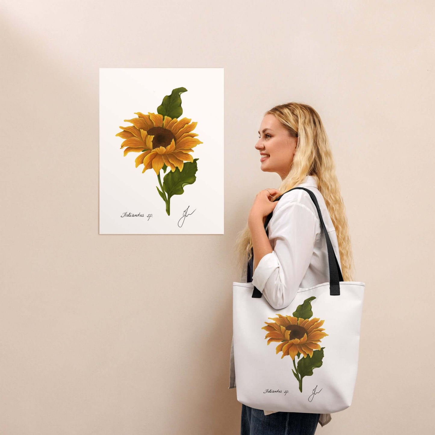 Woman holding a large sunflower tote bag next to a sunflower art print, showcasing style and functionality.