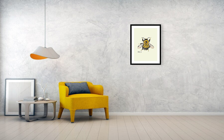 bumblebee-fine art print with black frame hanging on a wall next to a yellow sofa and a lamp