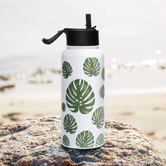 Side view on the beach: Sleek and modern monstera water bottle, complementing your beach attire.