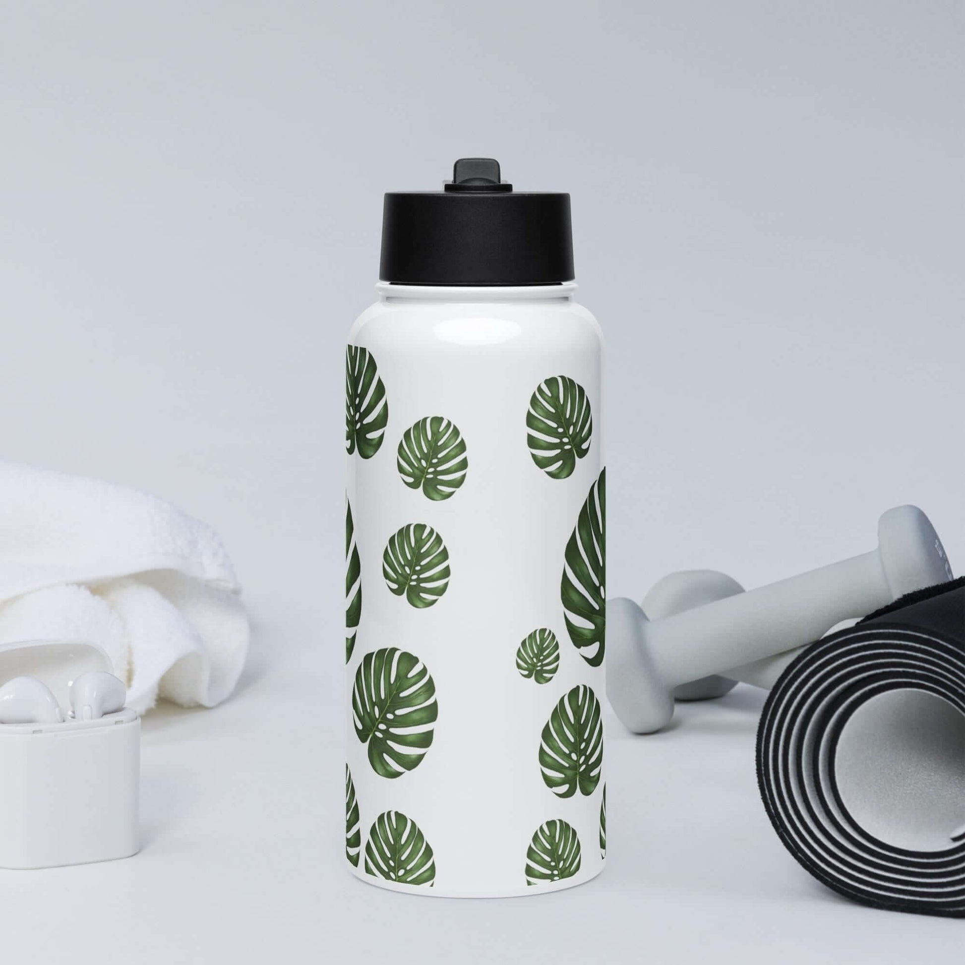 Front view in the gym: Energetic monstera water bottle, fueling your workout with hydration.