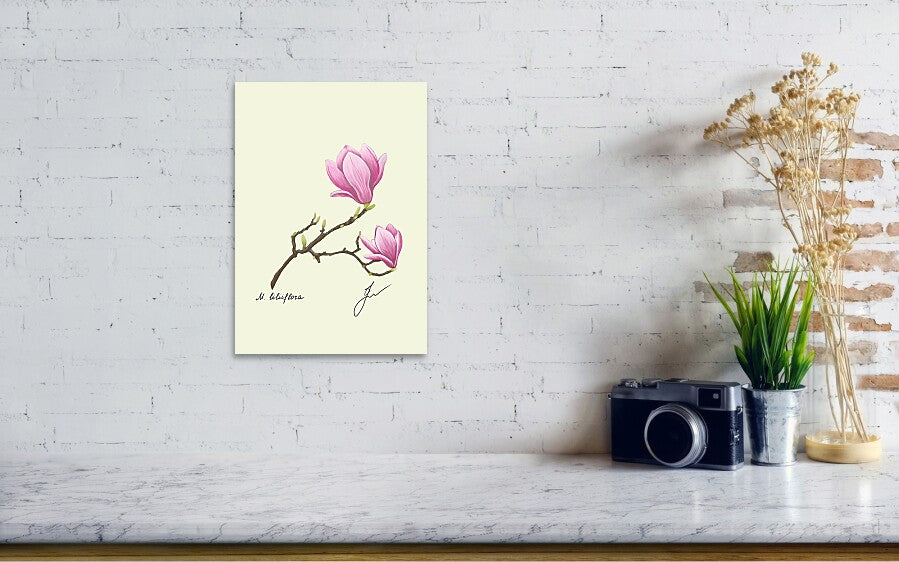 Magnolia art print on a wall, next to a vintage camera standing on a marble wall.