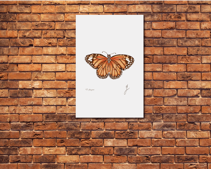 monarch butterfly on metal poster on a red brick wall